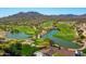Picturesque golf course and scenic lake with lush green fairways, surrounded by beautiful mountain views at 21008 W Cora Vis, Buckeye, AZ 85396