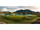 Picturesque golf course view with a pond, sand trap, and mountain backdrop at 21008 W Cora Vis, Buckeye, AZ 85396