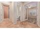 Hallway with tile flooring leads to various rooms, showcasing the home's open layout and accessibility at 21008 W Cora Vis, Buckeye, AZ 85396