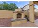 Backyard features an outdoor fireplace with stone accents and a seating area, perfect for entertaining at 21008 W Cora Vis, Buckeye, AZ 85396