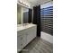 Bathroom with white vanity and tub with black and white striped shower curtain at 2143 N 30Th St, Mesa, AZ 85213