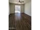 Well lit living room with a sliding glass door and dark wood flooring at 2143 N 30Th St, Mesa, AZ 85213