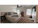 Inviting bedroom with neutral decor, plush carpeting, and bright natural light from the windows at 22461 W Woodlands Ave, Buckeye, AZ 85326