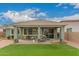 Cozy covered patio area with outdoor seating and lush artificial turf at 22552 E Via Estancia --, Queen Creek, AZ 85142