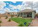 A well-maintained backyard with artificial turf and a covered patio at 22552 E Via Estancia --, Queen Creek, AZ 85142