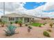 Landscaped backyard featuring desert plants, a covered patio, and artificial turf at 22552 E Via Estancia --, Queen Creek, AZ 85142