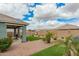Spacious backyard with desert landscaping, a covered patio, and artificial turf at 22552 E Via Estancia --, Queen Creek, AZ 85142