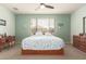 Light-filled bedroom with a large window, a ceiling fan, and wooden furniture at 22552 E Via Estancia --, Queen Creek, AZ 85142