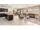 Open-concept kitchen and living area with modern furnishings, tile flooring, and ample natural light creating a welcoming space at 22552 E Via Estancia --, Queen Creek, AZ 85142