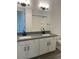 Bathroom featuring double sinks, granite countertops, and white cabinets at 231Xx W Gloria Ln, Wittmann, AZ 85361