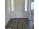 Bright entryway featuring wood look tile flooring, a white front door, and side windows at 231Xx W Gloria Ln, Wittmann, AZ 85361