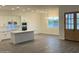 Open-concept kitchen featuring a quartz island, stainless steel appliances, and wood look tile flooring at 231Xx W Gloria Ln, Wittmann, AZ 85361