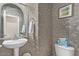 Stylish powder room featuring designer wallpaper, a pedestal sink, and modern fixtures at 2325 W Mineral Rd, Phoenix, AZ 85041