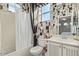 Bathroom featuring a tub with shower, stylish wallpaper, sink vanity, and ample natural light at 2325 W Mineral Rd, Phoenix, AZ 85041