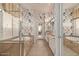 Bathroom with a soaking tub, glass shower, double vanity, tile flooring, and decorative wallpaper at 2325 W Mineral Rd, Phoenix, AZ 85041