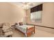 Cozy bedroom featuring a ceiling fan, warm-toned walls, a single bed, and soft natural lighting at 2325 W Mineral Rd, Phoenix, AZ 85041