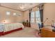 Bedroom with neutral walls, ceiling fan, desk, and two windows allowing natural light to illuminate the space at 2325 W Mineral Rd, Phoenix, AZ 85041