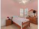 Bedroom featuring light pink walls, ceiling fan, two windows, and natural lighting at 2325 W Mineral Rd, Phoenix, AZ 85041