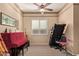 Multi-purpose bonus room featuring a piano, treadmill, ceiling fan, and window with modern blinds at 2325 W Mineral Rd, Phoenix, AZ 85041