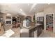 Well-equipped kitchen with an island bar, granite countertops, and seamless transition to the living area with a fireplace at 2325 W Mineral Rd, Phoenix, AZ 85041