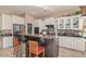 Stylish kitchen features white cabinets, granite countertops, and a functional island with seating for casual dining at 2325 W Mineral Rd, Phoenix, AZ 85041