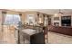 Open-concept kitchen with granite countertops, an island bar, and seamless transition to the living area with a fireplace at 2325 W Mineral Rd, Phoenix, AZ 85041