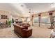 Bright living room showcasing tile and carpet floors, large windows, and seamless transition to the modern kitchen at 2325 W Mineral Rd, Phoenix, AZ 85041