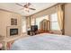 Tranquil main bedroom showcasing a fireplace, plush carpeting, and bright windows creating a cozy, relaxing atmosphere at 2325 W Mineral Rd, Phoenix, AZ 85041