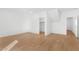 Bright bedroom with white walls and wood-look floors with closet and bathroom entrances at 2825 W Eagle Talon Rd, Phoenix, AZ 85085