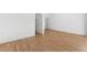 Bedroom featuring wood-look floors, white walls, and two doorways at 2825 W Eagle Talon Rd, Phoenix, AZ 85085