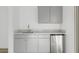 Kitchenette features gray cabinets, white countertops, and stainless steel refrigerator at 2825 W Eagle Talon Rd, Phoenix, AZ 85085