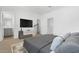 This bright main bedroom features neutral decor, a large television, and a large ensuite bathroom at 2825 W Eagle Talon Rd, Phoenix, AZ 85085