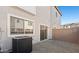 Private backyard area featuring gravel, AC unit, and slider to home's interior at 2832 W Eagle Talon Rd, Phoenix, AZ 85085