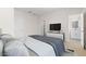 Comfortable bedroom with plush bedding, TV, and ensuite bathroom access offers relaxation at 2832 W Eagle Talon Rd, Phoenix, AZ 85085