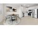 Bright kitchen with stainless appliances, white cabinets, and dining area, ideal for meals and entertaining guests at 2832 W Eagle Talon Rd, Phoenix, AZ 85085
