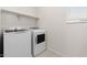 Efficient laundry room with modern washer and dryer, plus convenient shelving at 2832 W Eagle Talon Rd, Phoenix, AZ 85085