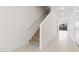 Hallway with a staircase featuring carpeted steps and modern railings leading to the upper level with views to the outside at 2832 W Eagle Talon Rd, Phoenix, AZ 85085