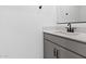 The bathroom has a single sink vanity with light countertops and modern, dark hardware at 2835 W Eagle Talon Rd, Phoenix, AZ 85085