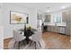 Stylish dining area adjacent to the kitchen featuring stainless steel appliances and sleek black table at 2835 W Eagle Talon Rd, Phoenix, AZ 85085