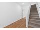 Bright hallway features wood-look flooring and a carpeted staircase to the upper level at 2835 W Eagle Talon Rd, Phoenix, AZ 85085