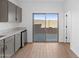Modern kitchenette includes gray cabinets, light countertops, and sliding glass door to patio at 2835 W Eagle Talon Rd, Phoenix, AZ 85085