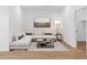This staged living room is furnished with a sofa, coffee table, area rug, and decorative art at 2835 W Eagle Talon Rd, Phoenix, AZ 85085