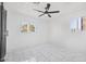 Well-lit bedroom boasts sleek tile flooring and updated features including a ceiling fan at 2921 W Luke Ave, Phoenix, AZ 85017