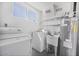Functional laundry area equipped with modern appliances, sink, and water heater at 2921 W Luke Ave, Phoenix, AZ 85017