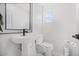 Clean powder room features a pedestal sink, modern fixtures, and tiled floors for a refreshing space at 2921 W Luke Ave, Phoenix, AZ 85017