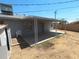 An open backyard features a covered patio, storage shed, and block wall fencing at 3347 E Palm Ln, Phoenix, AZ 85008
