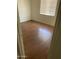 Cozy bedroom featuring wood-look flooring, neutral walls and a bright window at 3347 E Palm Ln, Phoenix, AZ 85008