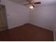 Spacious bedroom with ceiling fan and light fixture, neutral walls, and good closet space at 3347 E Palm Ln, Phoenix, AZ 85008