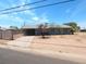 Street view of a single-story home with a paved driveway and block fence at 3347 E Palm Ln, Phoenix, AZ 85008
