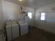 Utility room with laundry machines, water heater, sink, and access to the outside at 3347 E Palm Ln, Phoenix, AZ 85008